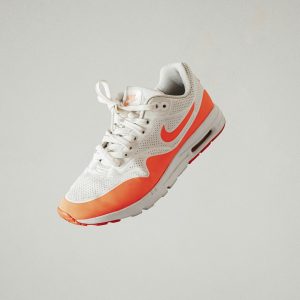 white and red nike athletic shoe